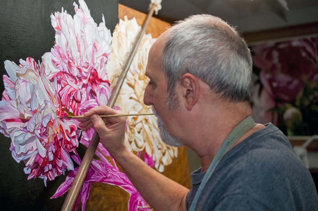 Baldassini in studio painting flowers